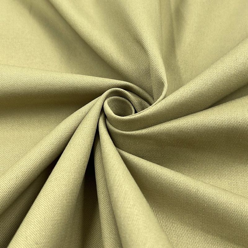 A close-up of draped fabric in a muted khaki color, arranged in a spiral pattern to show the material's texture and drape.