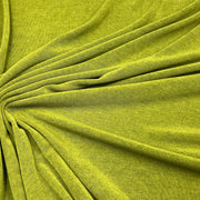 A close-up of draped olive green fabric with a textured, heathered finish, arranged in soft folds radiating from the center.