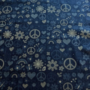 A close-up of a dark navy blue fabric with a repeating pattern of light gray peace signs, hearts, flowers, and small rainbows.