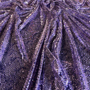 Close-up of shimmering purple sequined mesh fabric with a textured, pleated appearance.