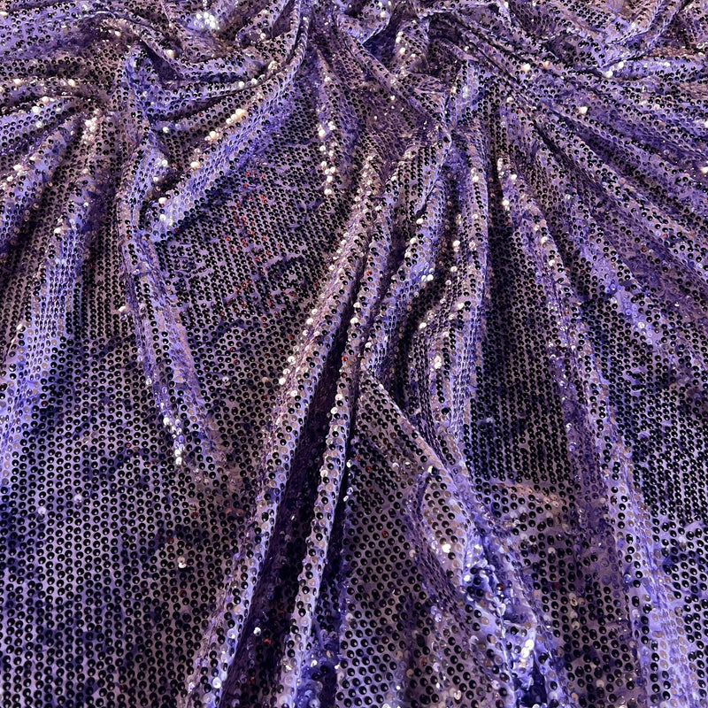 Close-up of shimmering purple sequined mesh fabric with a textured, pleated appearance.