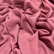 Lightweight 100% cotton bubble gauze in rich mauve pink color delicately ruffled into a pile showing off soft hand and drapeability