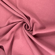 Lightweight 100% cotton bubble gauze in rich mauve pink color pulled into a delicate swirl showing off soft texture and lightweight hand