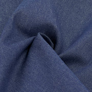 A close-up of dark blue denim fabric with a visible twill weave and soft folds.