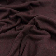 A close-up of draped fabric with a fine woven texture in a very dark burgundy-brown color, showing folds and the material's subtle heathering.