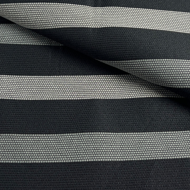 A close-up of a woven fabric with horizontal stripes in black and light gray, showing the texture and pattern details.