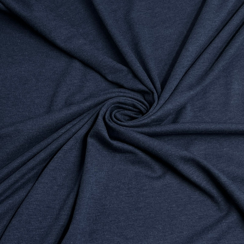 A close-up of dark navy blue heathered fabric arranged in a spiral drape, showing the material texture and color.