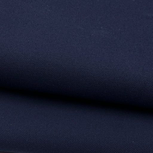 A close-up of dark navy blue canvas fabric with a visible woven texture, shown in two folded layers.