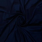 Dark navy blue fabric draped in a spiral swirl pattern, showing a smooth texture and subtle sheen.