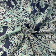 A lightweight sheer fabric with an intricate botanical damask pattern in navy blue, mint green, and cream, styled with a central swirl.