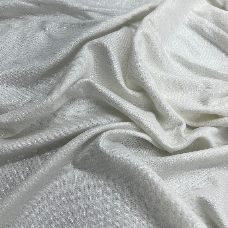 A close-up of draped white French terry with a subtle sheen and soft folds filling the frame.