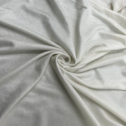 A close-up of draped metallic French terry with a subtle sheen, shown arranged in a spiral fold pattern.