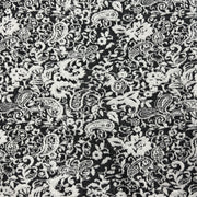 Black and white damask fabric with an intricate floral and paisley pattern.