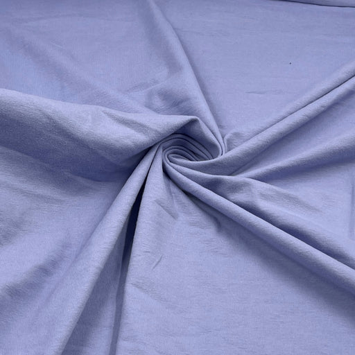 Light periwinkle blue fabric draped in a spiral pattern to show its texture and drape.