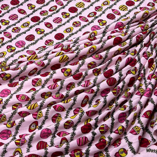 Pink striped cotton jersey in pink featuring lines of christmas ornaments