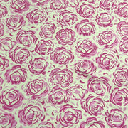 A close-up of a repeating floral pattern featuring pink roses on a light cream background.
