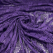 Purple open-knit fabric with a textured, sheer mesh pattern, arranged in a spiral drape to show its texture and color.