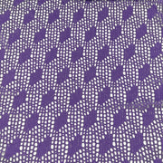Purple and white patterned lace fabric with a repeating openwork floral and geometric design.