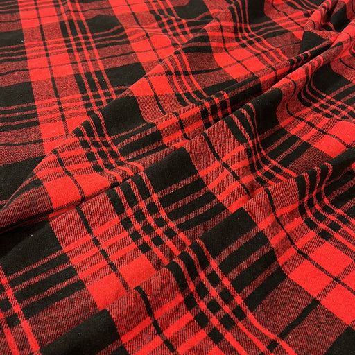 Red and black buffalo plaid fabric with a soft draped texture.