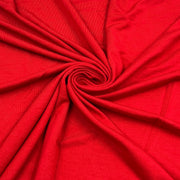 Bright red fabric draped in a spiral pattern, showing its texture and color.