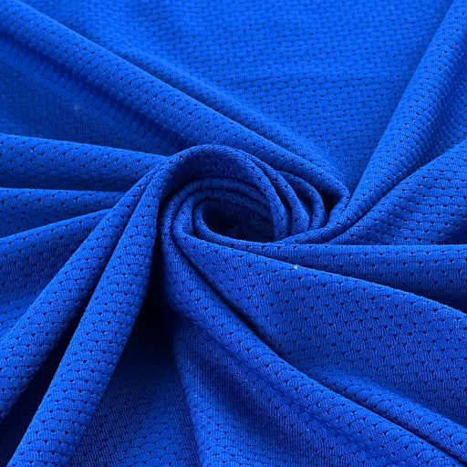 Closeup of polyester athletic jersey mesh folded into a swirl showing off soft drape and smooth texture. 