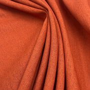 Closeup of rust orange laundered linen fabric.