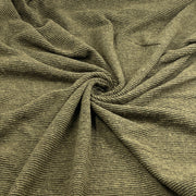 A close-up of olive green ribbed fabric, gathered in the center to show its texture and drape.
