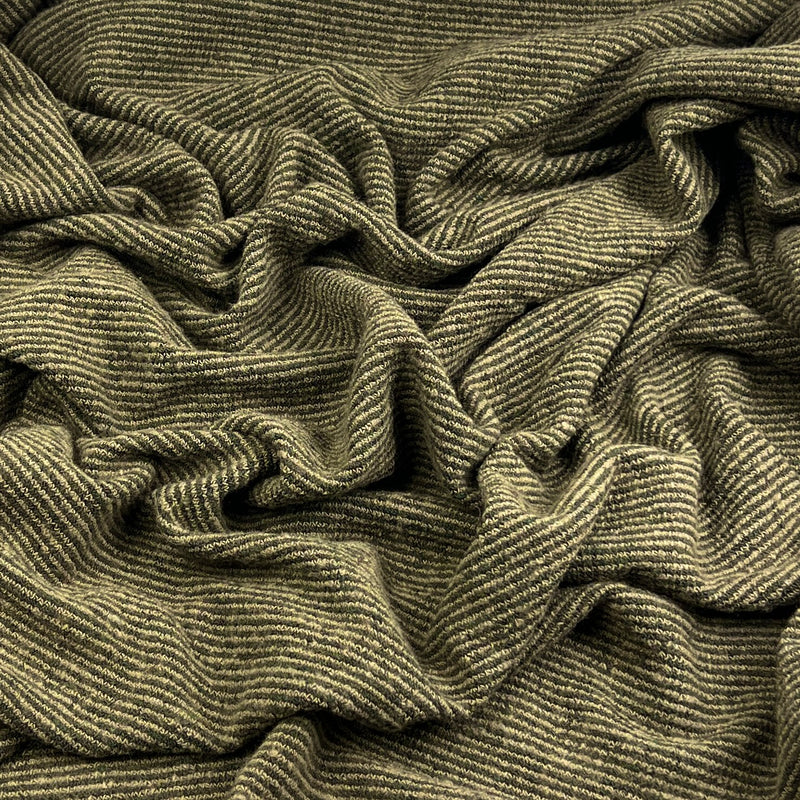 A close-up of a textured, olive green and beige striped knit fabric with a ribbed pattern, shown in soft folds.