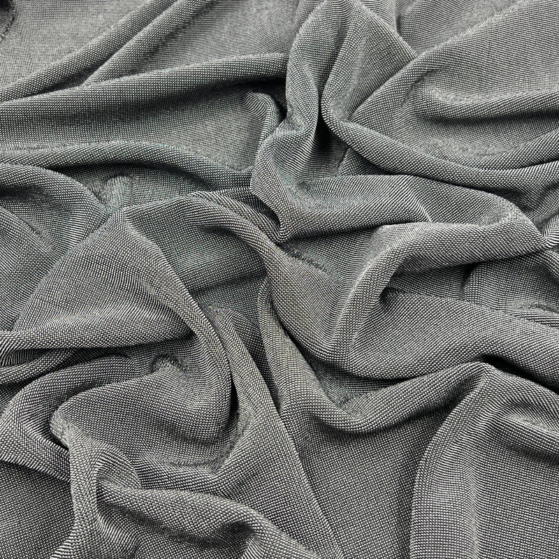 A close-up of draped gray fabric with a fine ribbed or waffle-like texture, filling the entire frame.