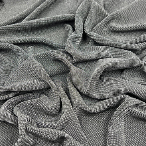 A close-up of draped gray fabric with a fine ribbed or waffle-like texture, filling the entire frame.
