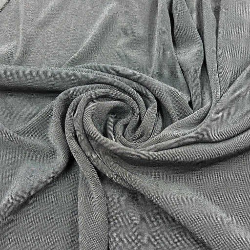 A close-up of draped gray fabric arranged in a spiral, showing the material texture and color.