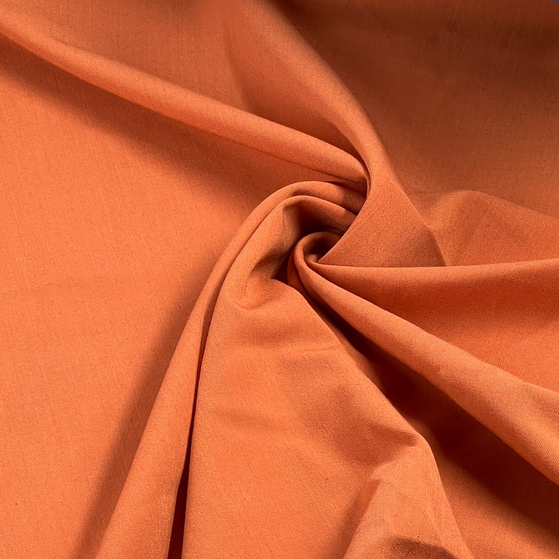 Close-up of orange fabric with folds