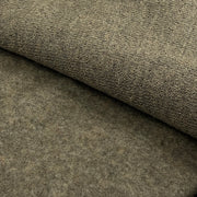 A close-up of a textured fabric or felt material in a warm taupe-brown color, with one corner folded over to show the surface texture.