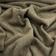 A close-up of draped olive green knit fabric with a soft, textured weave.
