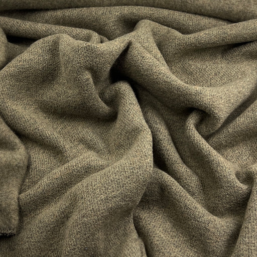 A close-up of draped olive green knit fabric with a soft, textured weave.