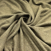 A close-up of draped olive green ribbed knit fabric, showing its soft texture and woven pattern.