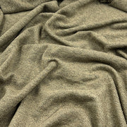 A close-up of draped olive green textured fabric with a ribbed knit pattern.