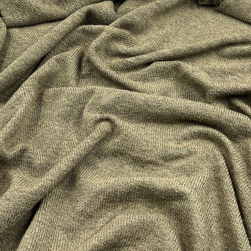 A close-up of draped olive green textured fabric with a ribbed knit pattern.