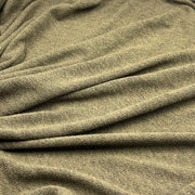 A close-up of draped olive green textured fabric with soft folds and a fine woven surface.