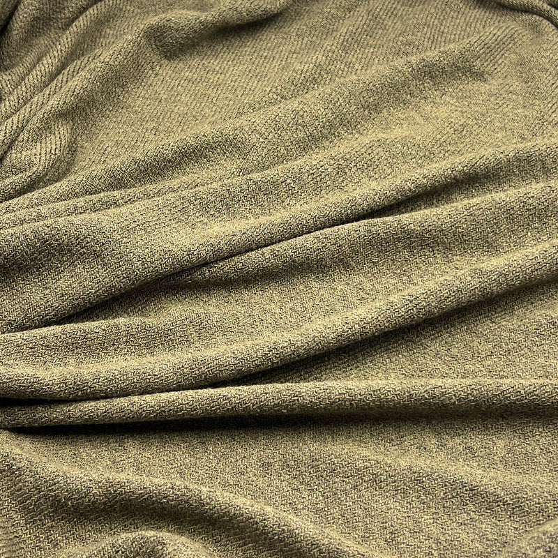A close-up of draped olive green textured fabric with soft folds and a fine woven surface.