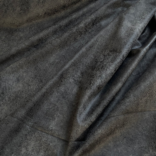 Dark charcoal gray textured fabric with a distressed, pebbled finish, shown draped in soft folds.