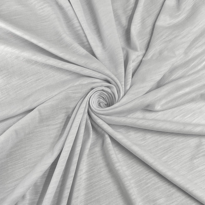 A close-up of light gray fabric arranged in a spiral drape, showing the material texture and soft folds.