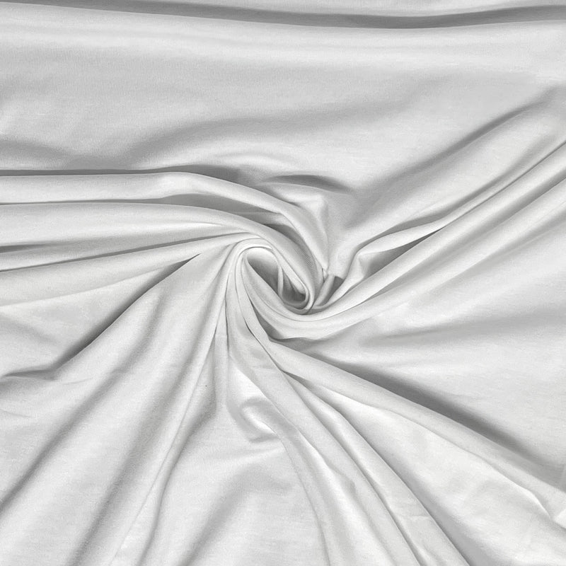 White fabric with a smooth, slightly lustrous texture, arranged in a central swirl to show off its drape and soft folds.