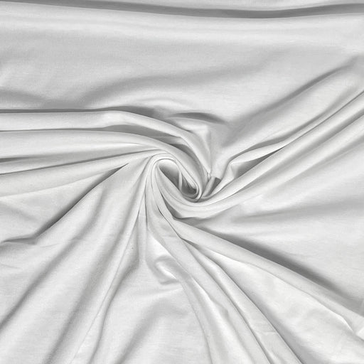 White fabric with a smooth, slightly lustrous texture, arranged in a central swirl to show off its drape and soft folds.