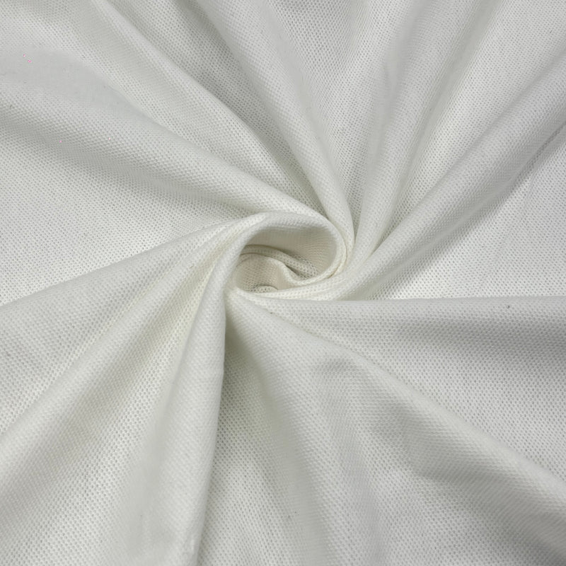 A close-up of white textured fabric arranged in a spiral drape, showing the woven material and subtle shadows.
