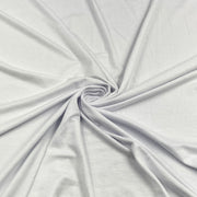 White fabric draped in a spiral pattern to show its soft texture and drape.