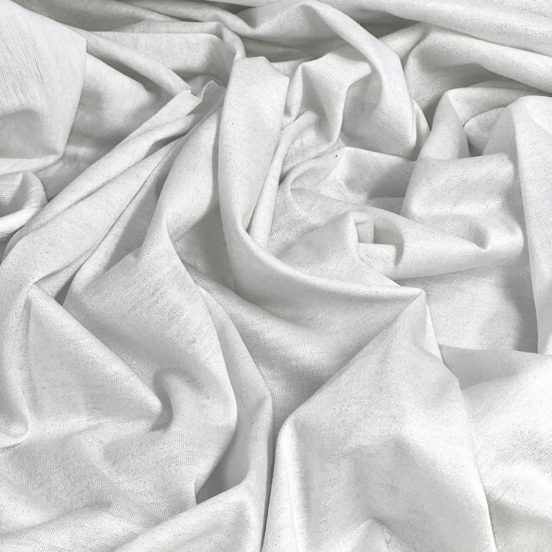 Close-up of white fabric with gold metallic lurex threads