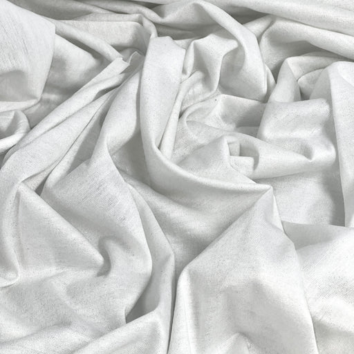 Close-up of white fabric with gold metallic lurex threads