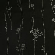 Black fabric with delicate silver floral and vine embroidery.