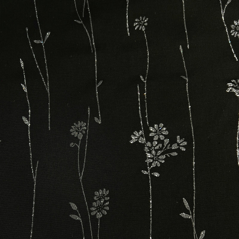 Black fabric with delicate silver floral and vine embroidery.